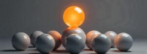 Golden sphere rising above identical grey spheres, symbolizing market leadership, differentiation, and brand uniqueness.
