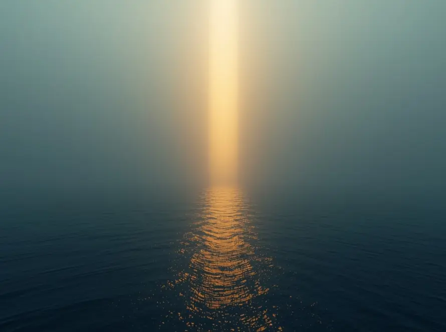 Vertical beam of golden light breaking through fog over ocean symbolizing strategic visibility and clarity in uncertain markets