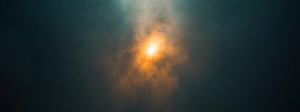 Golden light scattering through dense teal fog between abstract structures, symbolizing visibility without clarity and the loss of market authority through ambiguity.